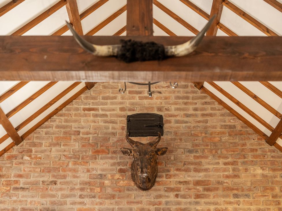 A wall with a bull head and horns in a rustic interior at The Dairy in Corwen