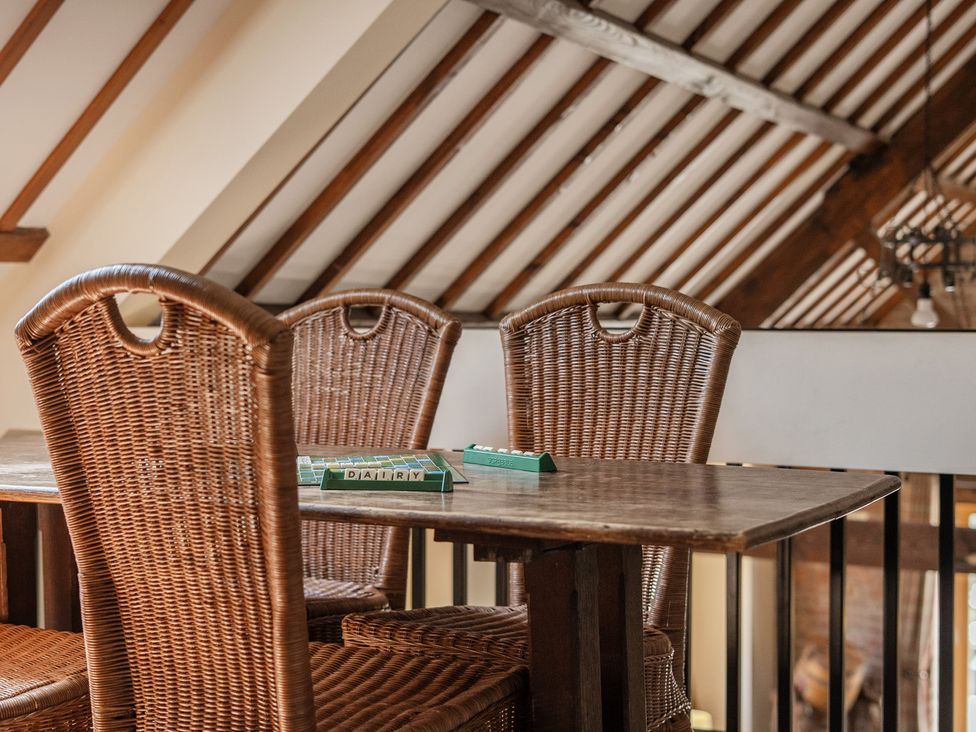 A dining room with a table and chairs at The Dairy in Corwen