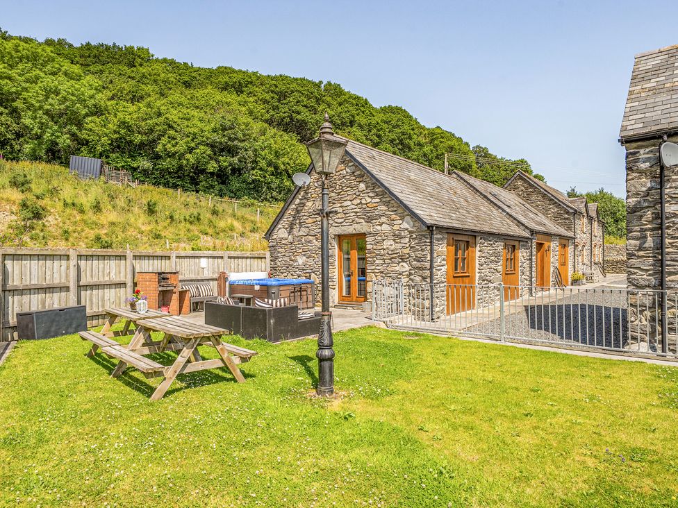 An outdoor area with buildings and furniture at The Dairy Corwen