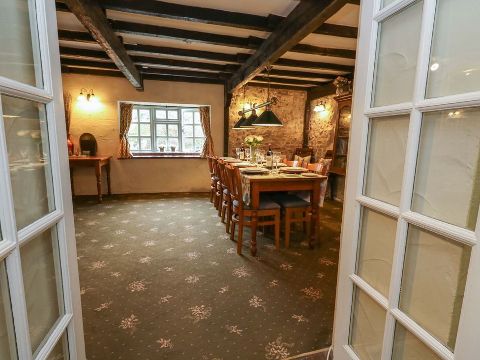 A dining room with a table and chairs at Piddle Inn Piddletrenthide