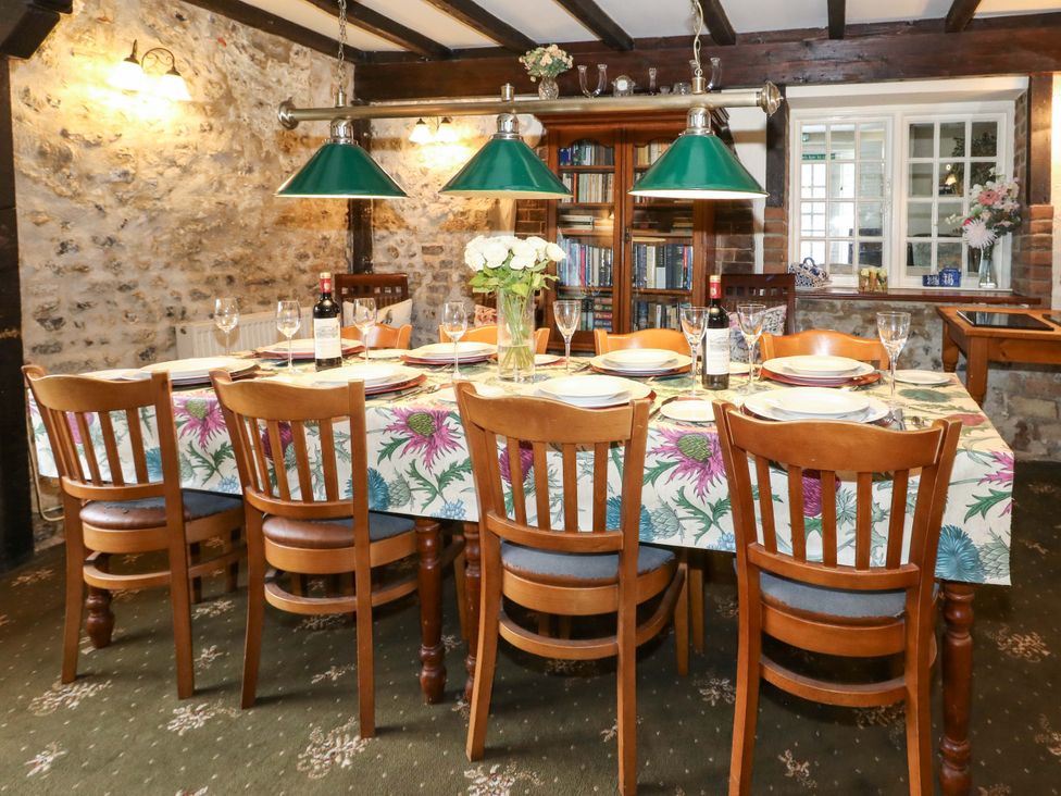 A dining room with a table set for dinner at Piddle Inn in Piddletrenthide