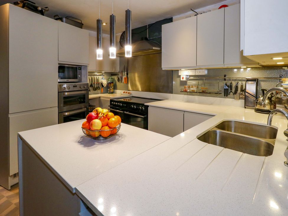 A kitchen with a countertop and fruit bowl at Piddle Inn in Piddletrenthide
