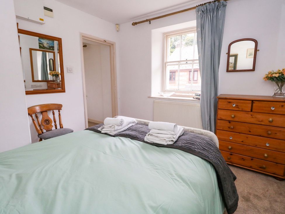 A bedroom with a bed and dresser at Piddle Inn in Piddletrenthide
