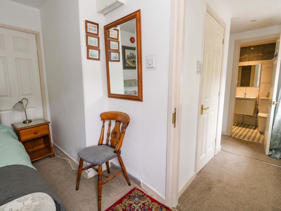 A bedroom with a chair and lamp at Piddle Inn in Piddletrenthide