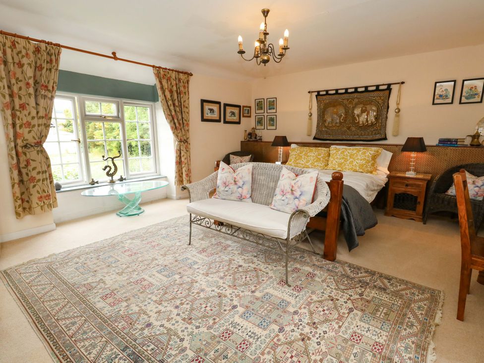 A bedroom with a bed and decorative items at Piddle Inn Piddletrenthide