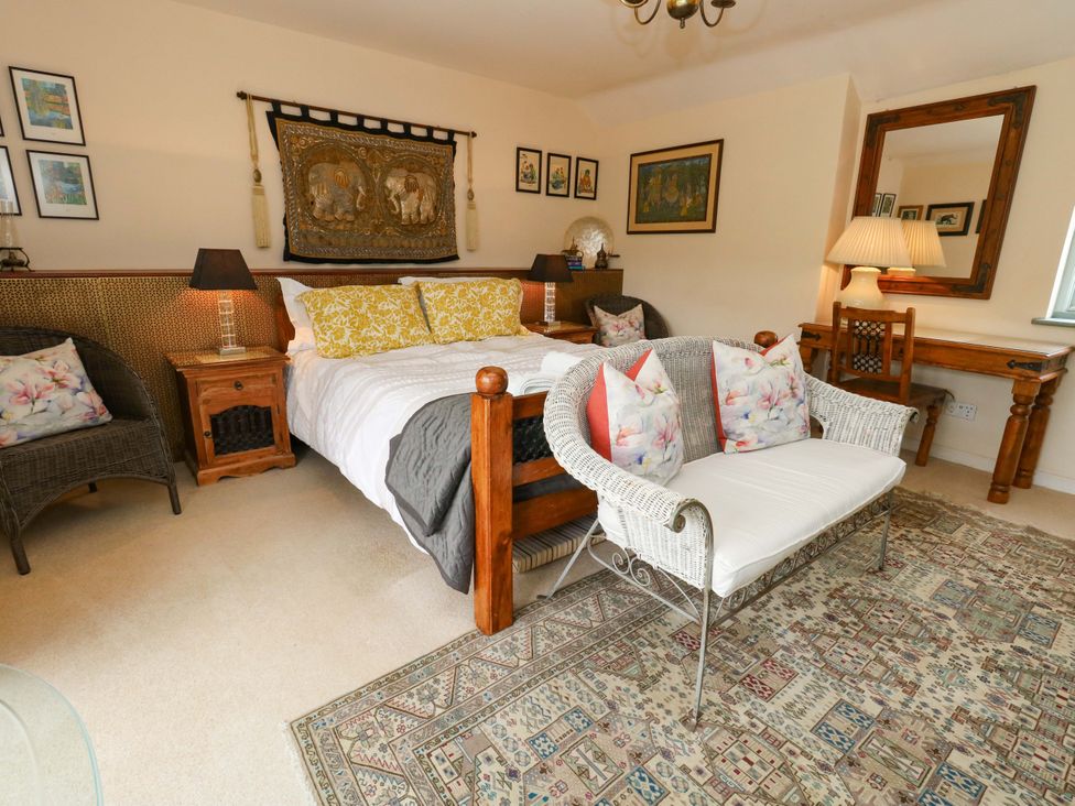 A bedroom with a bed and a sofa at Piddle Inn in Piddletrenthide