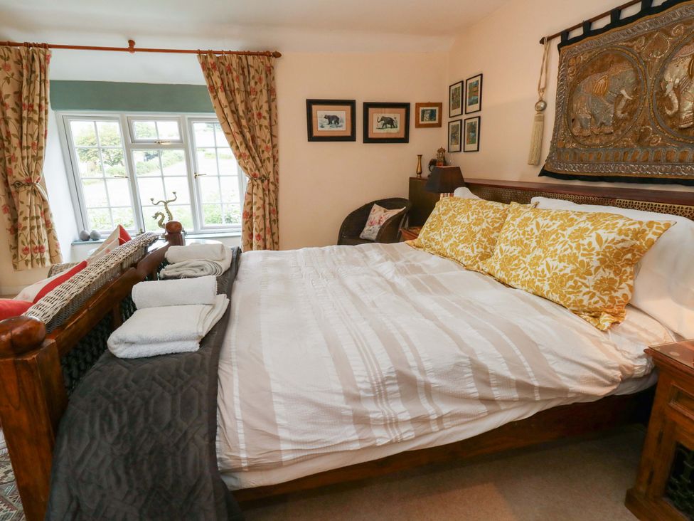 A bedroom with a bed and decorative pillows at Piddle Inn Piddletrenthide