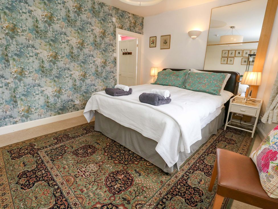 A bedroom with a bed and nightstands at Piddle Inn in Piddletrenthide