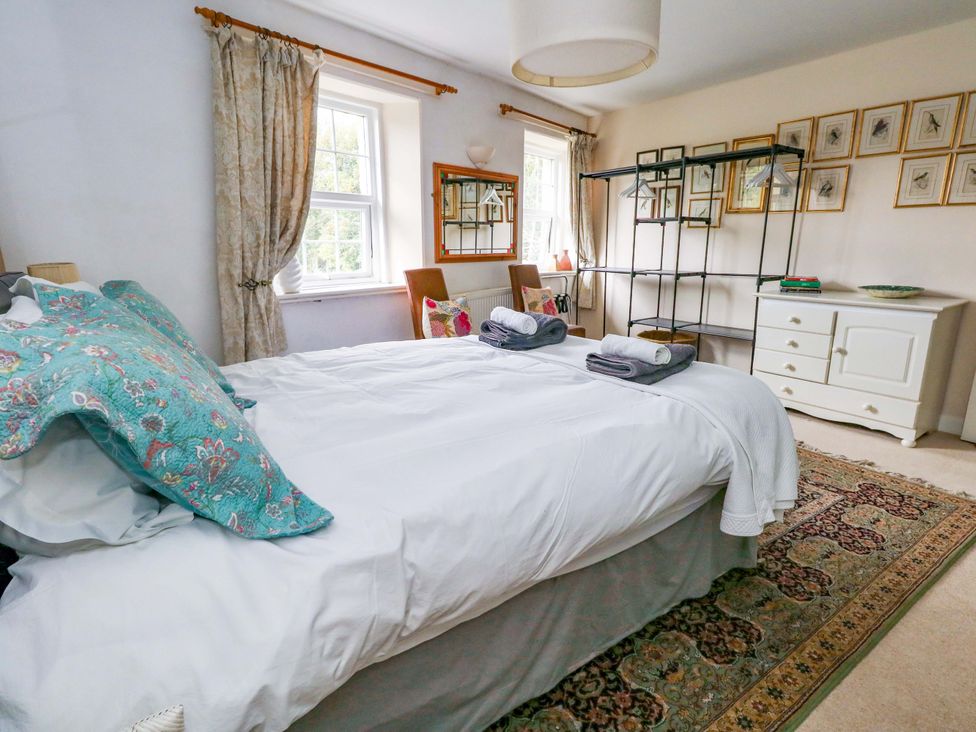 A bedroom with a bed and dresser at Piddle Inn Piddletrenthide