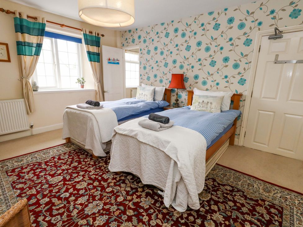 A bedroom with two single beds and window at Piddle Inn in Piddletrenthide