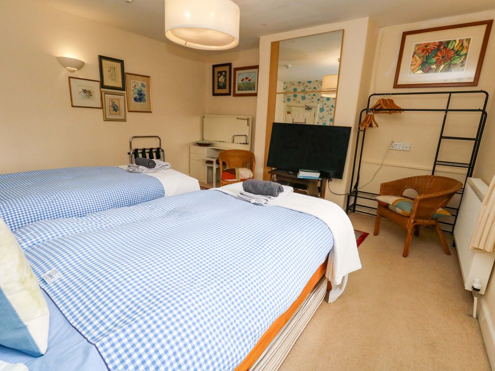 A bedroom with two beds and a television at Piddle Inn in Piddletrenthide