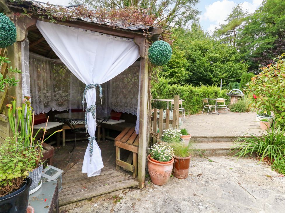A gazebo with seating area in a garden at Piddle Inn in Piddletrenthide