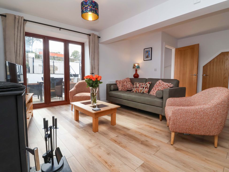A living room with a sofa and coffee table at Butterfly Days in Bideford