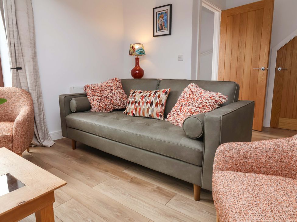 A living room with a sofa and chair at Butterfly Days in Bideford