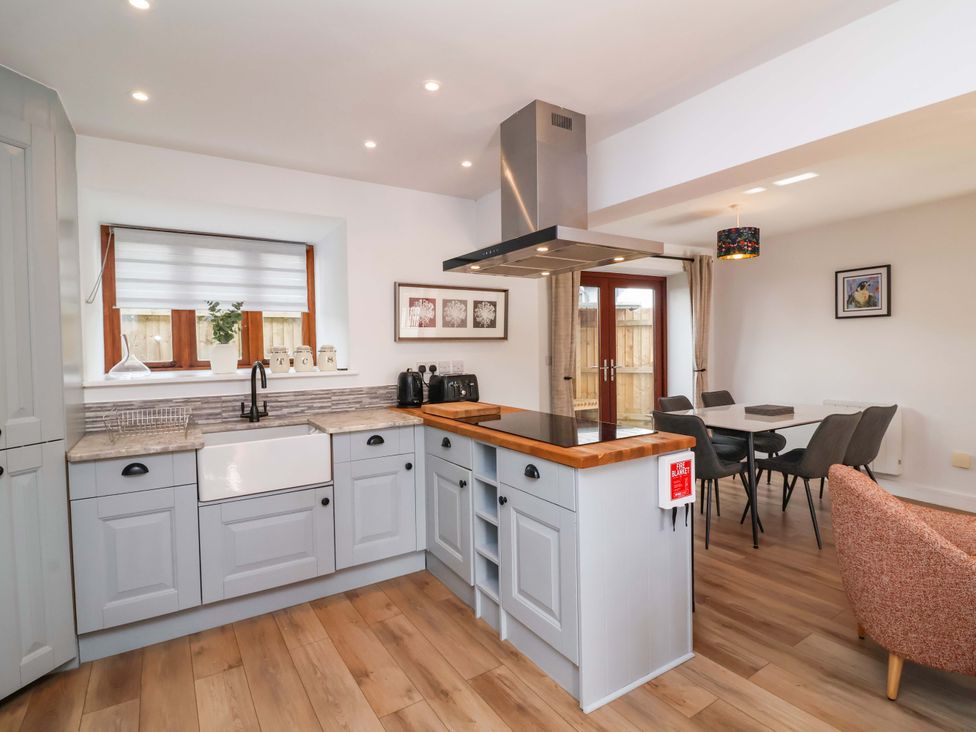 A kitchen with a sink and island at Butterfly Days in Bideford