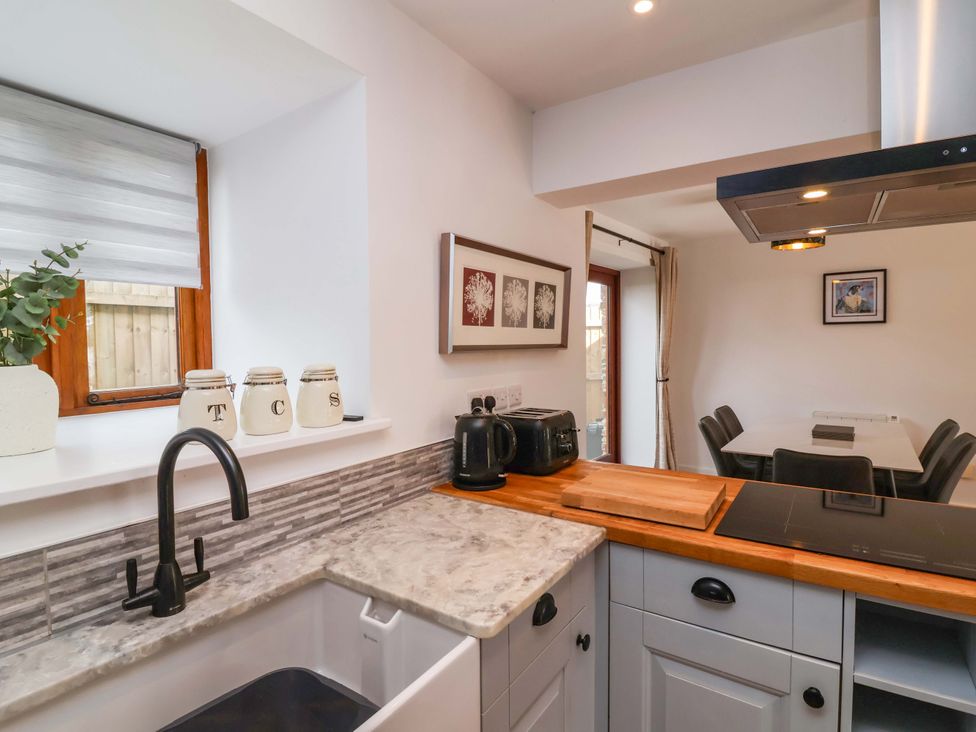 A kitchen with a sink and appliances at Butterfly Days in Bideford