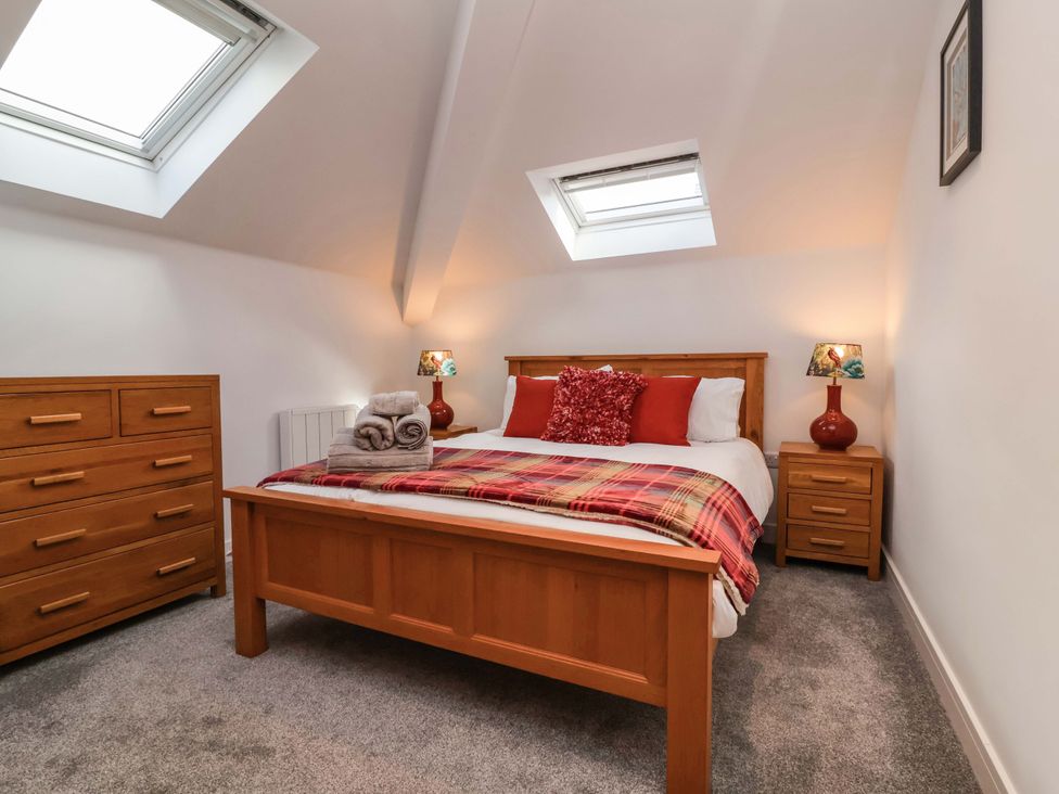 A bedroom with a bed and furniture at Butterfly Days in Bideford