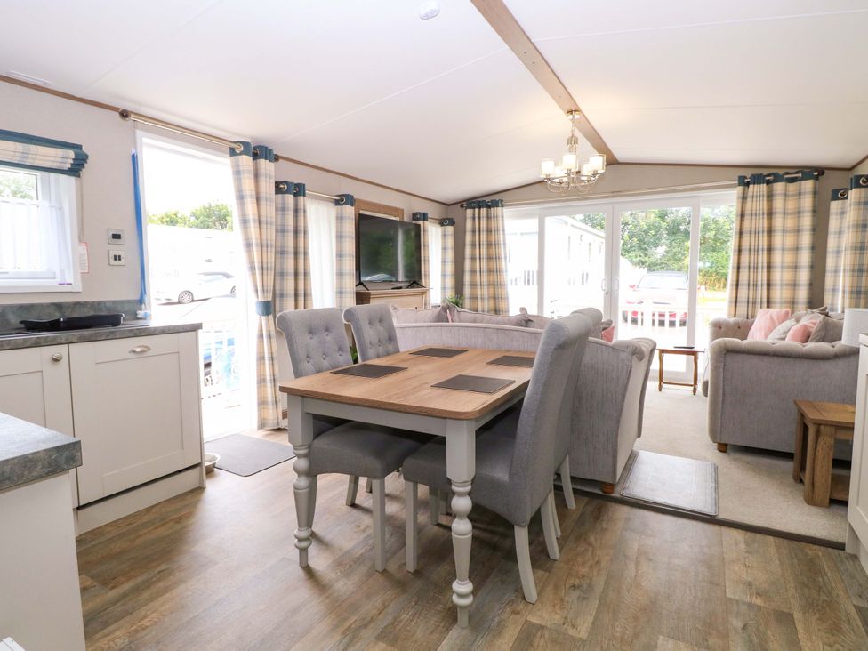 A living room with a dining table and sofa at 17 Castle Walk in Great Yarmouth