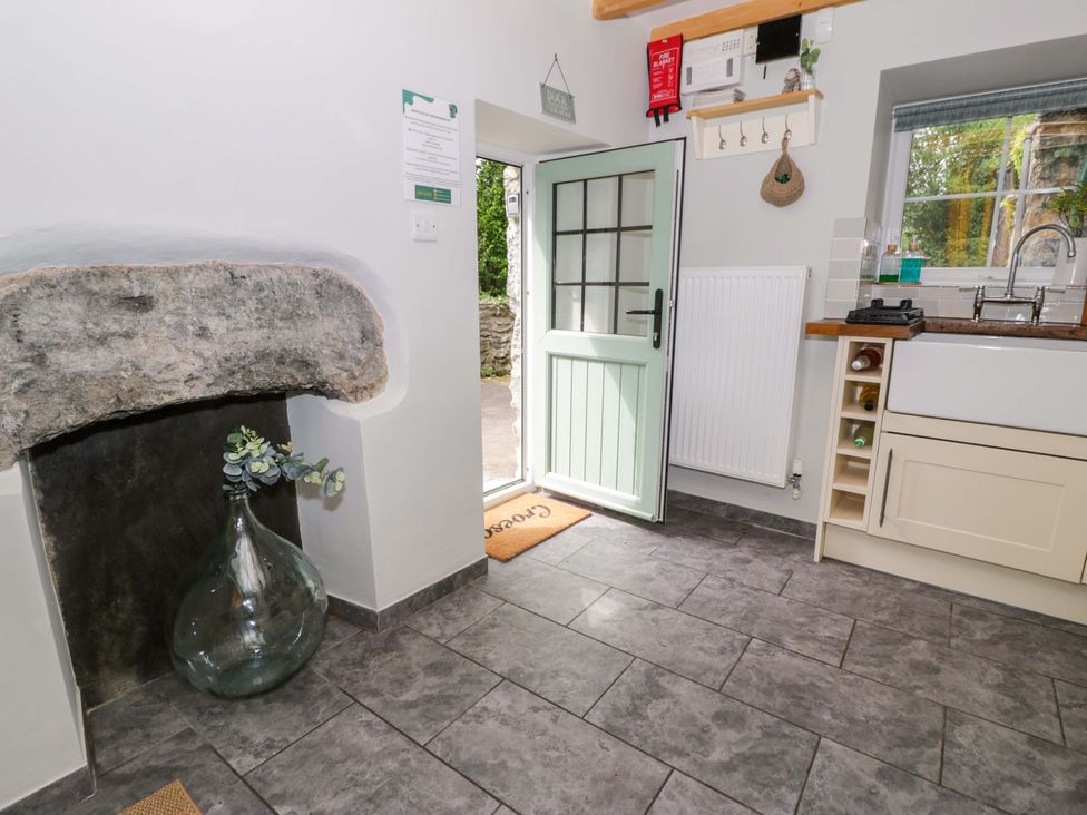 A kitchen with a door and window at Brondderwen in Blaenau Ffestiniog