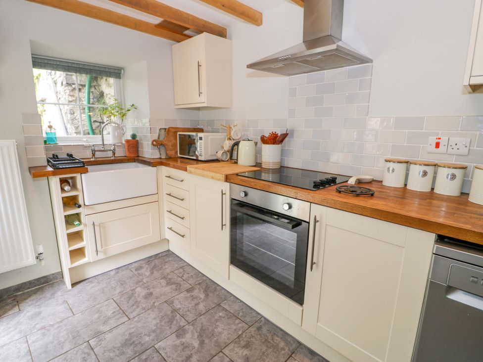 A kitchen with a sink and oven at Brondderwen in Blaenau Ffestiniog