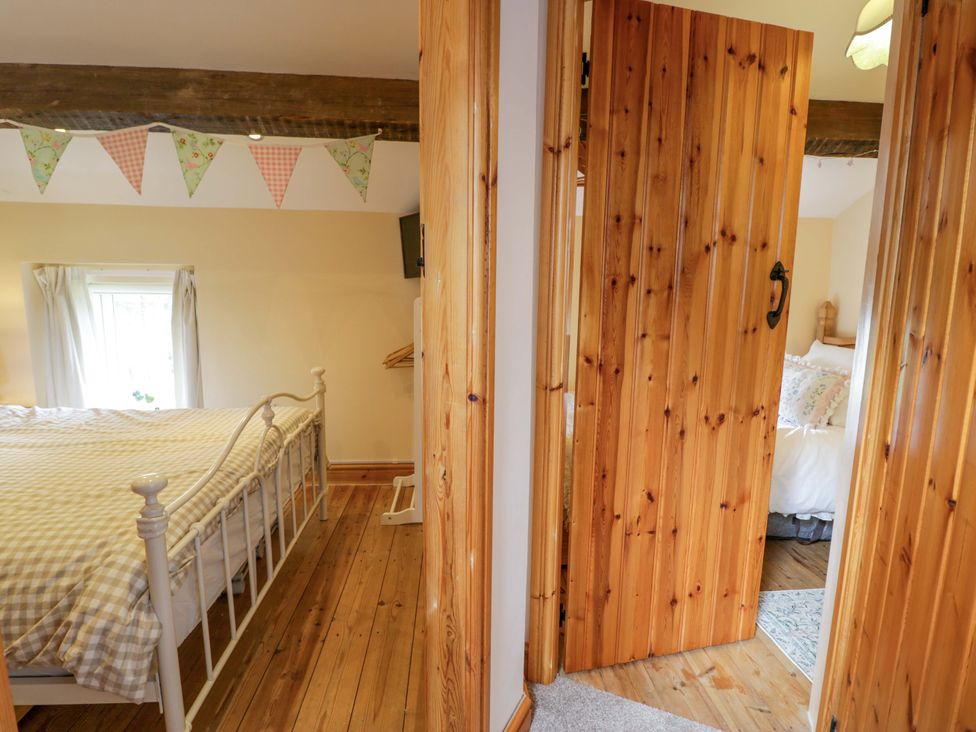 A bedroom with a bed and a door at Brondderwen in Blaenau Ffestiniog