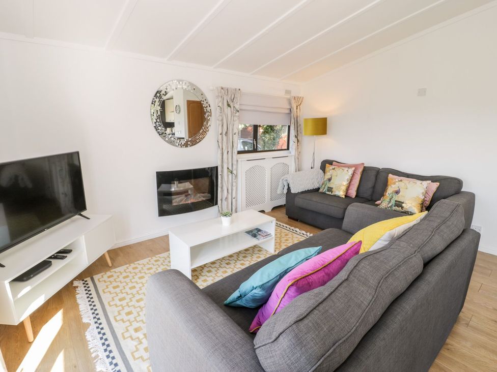 A living room with a sofa and television at Summertime Lodge Rhyd-y-Foel near Abergele