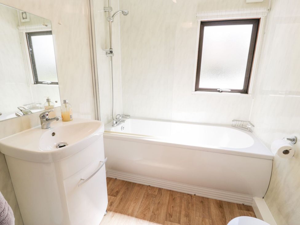 A bathroom with a sink and bathtub at Summertime Lodge Rhyd-y-Foel near Abergele