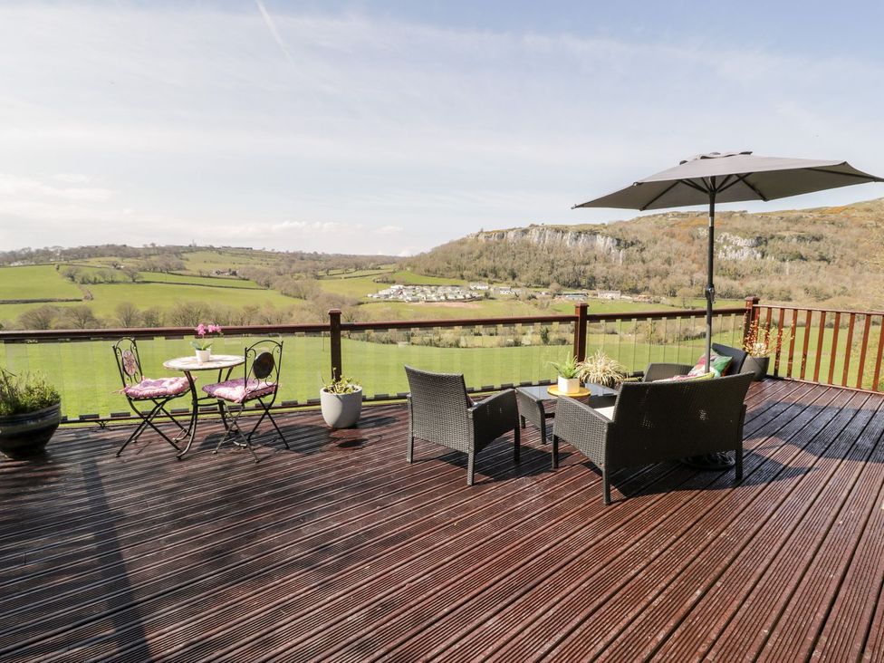 An outdoor seating area with a table and chairs at Summertime Lodge Rhyd-y-Foel near Abergele