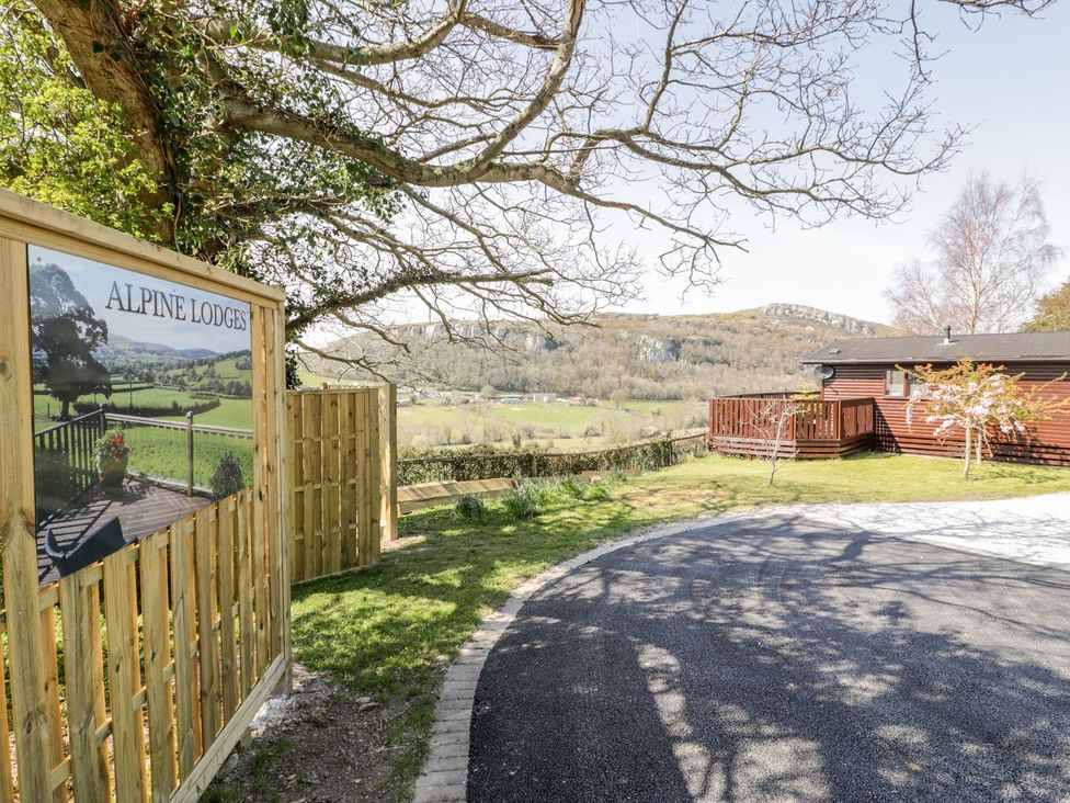 An outdoor area with a sign for Alpine Lodges at Springtime Lodge Rhyd-y-Foel near Abergele