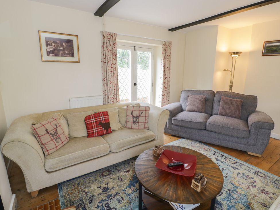 A living room with a sofa and coffee table at Hillside Cottage