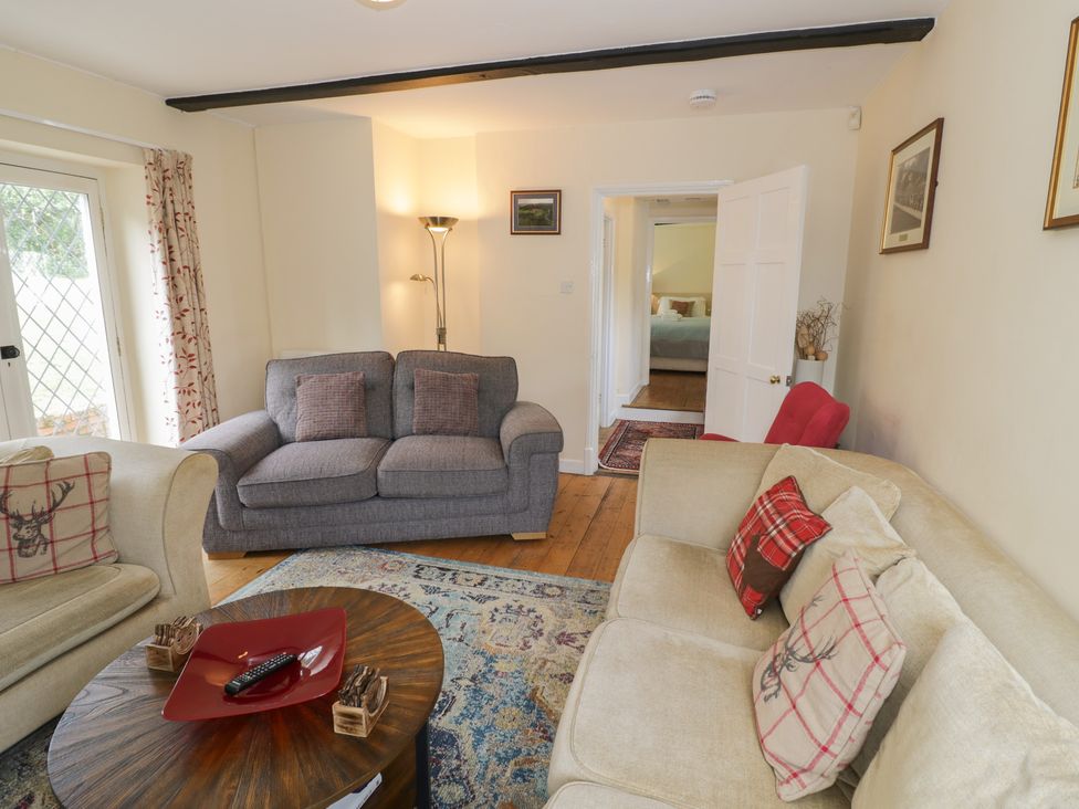 A living room with sofas and a coffee table at Hillside Cottage 