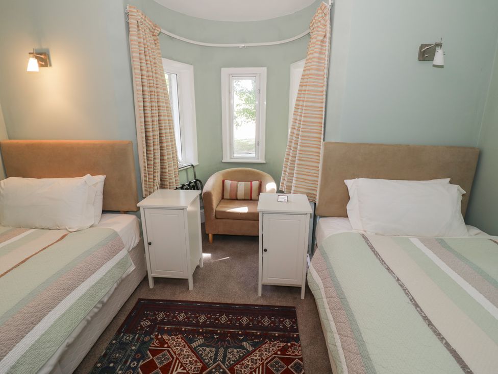 A bedroom with two beds and a couch at Boxbush Lodge in Monmouth