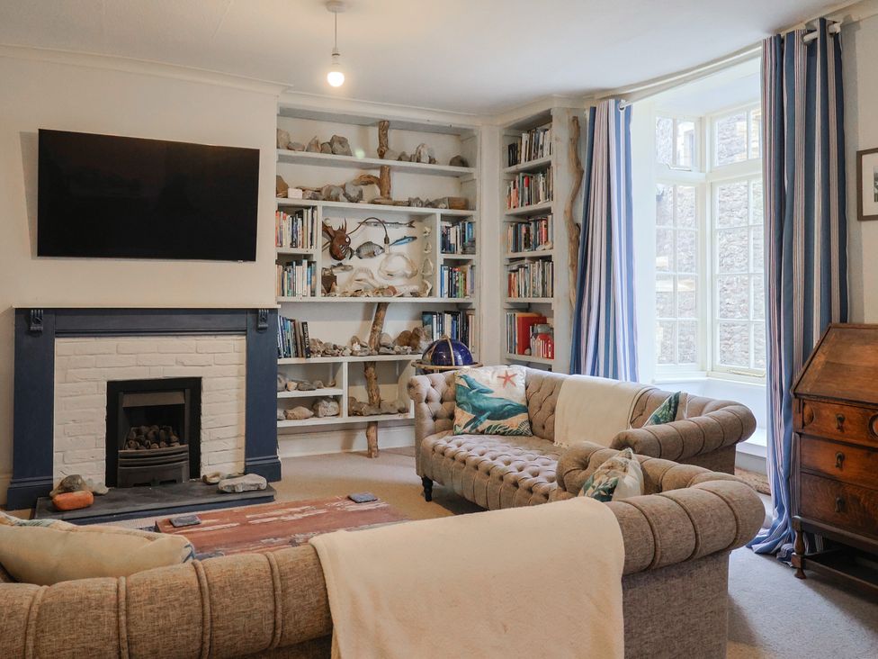 A living room with a television and bookshelf at 5B Bridge Street in Lyme Regis