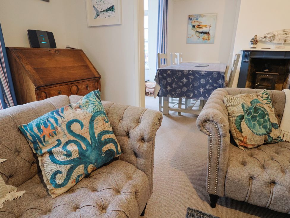A living room with sofas and a dining table at 5B Bridge Street in Lyme Regis