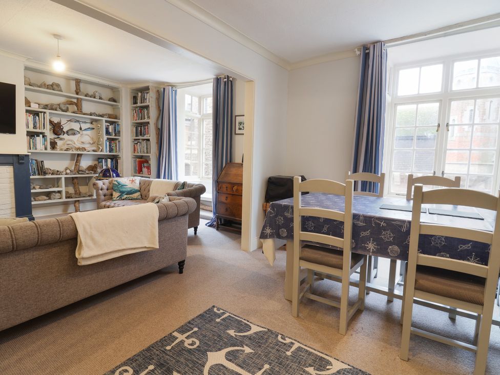 A living room with a sofa and dining table at 5B Bridge Street in Lyme Regis