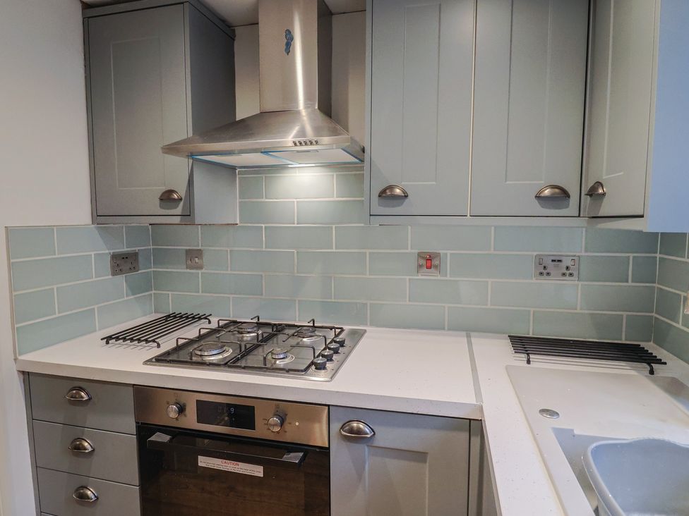 A kitchen with a gas hob and ventilation hood at 5B Bridge Street in Lyme Regis