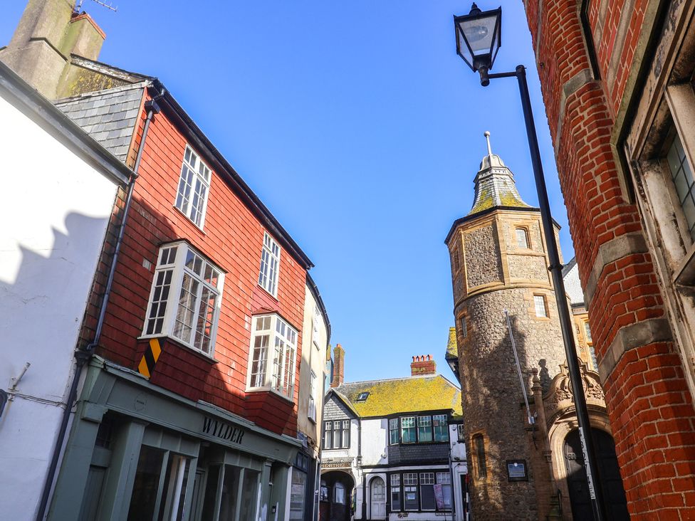 Buildings and a stone tower in a street setting at 5B Bridge Street in Lyme Regis