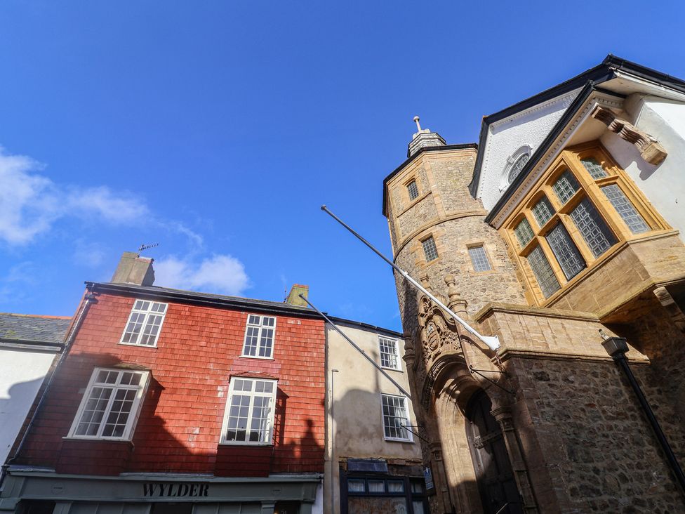 Two buildings with windows and a sign at 5B Bridge Street Lyme Regis