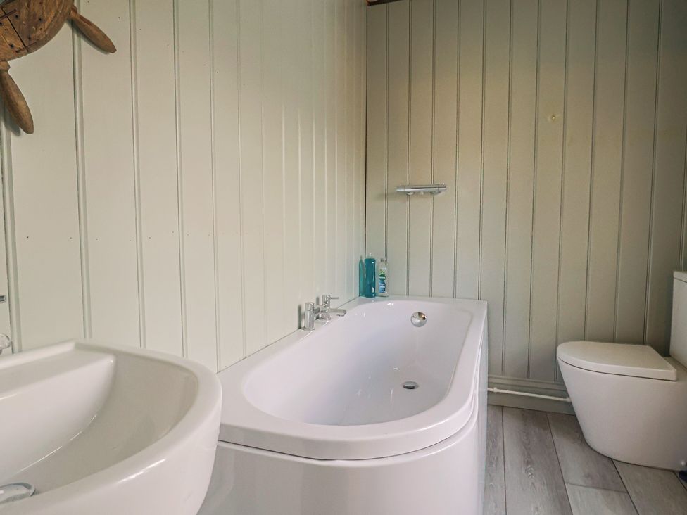 A bathroom with a bathtub and a sink at 5B Bridge Street Lyme Regis