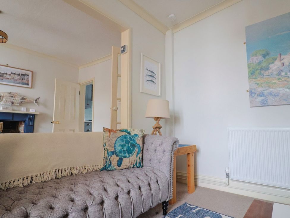 A living room with a sofa and lamp at 5B Bridge Street in Lyme Regis