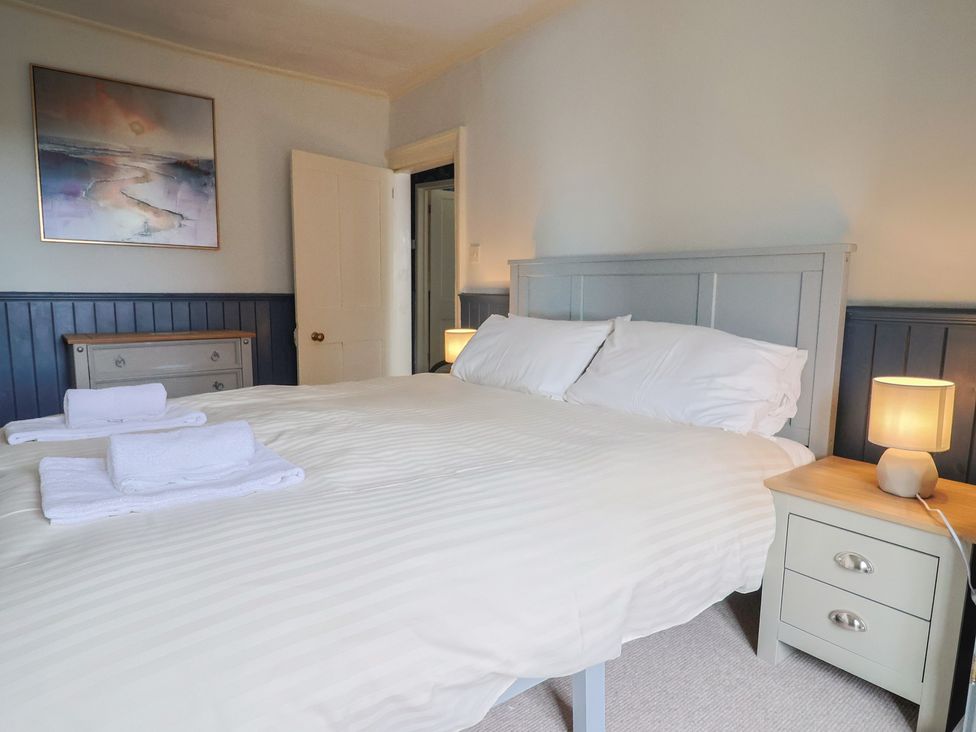 A bedroom with a bed and side tables at 5B Bridge Street in Lyme Regis