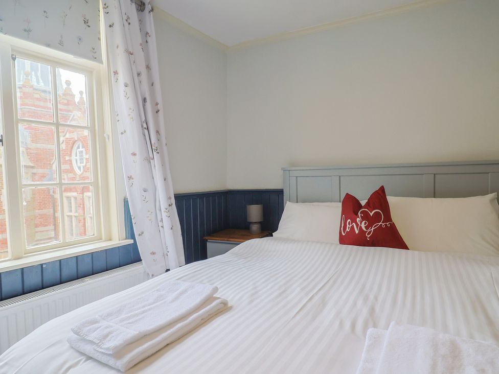 A bedroom with a bed and window at 5B Bridge Street Lyme Regis