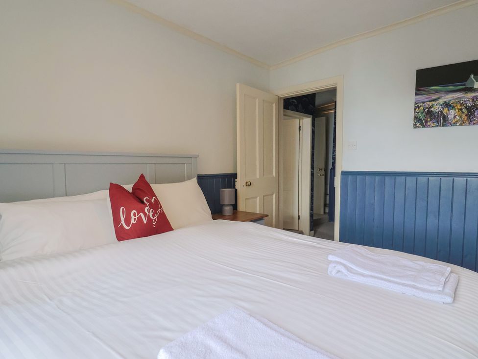 A bedroom with a bed and pillows at 5B Bridge Street Lyme Regis