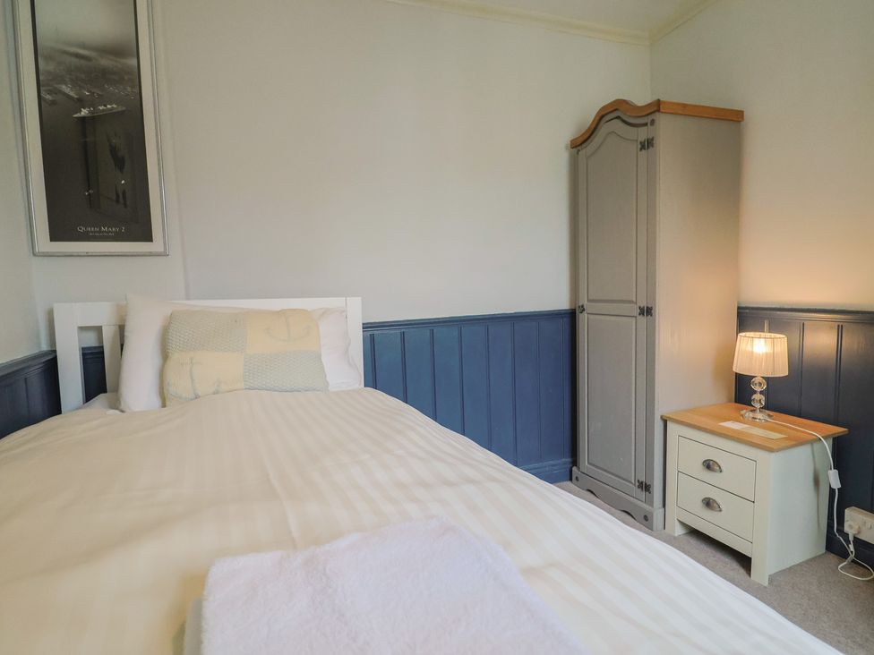 A bedroom with a bed and nightstand at 5B Bridge Street Lyme Regis