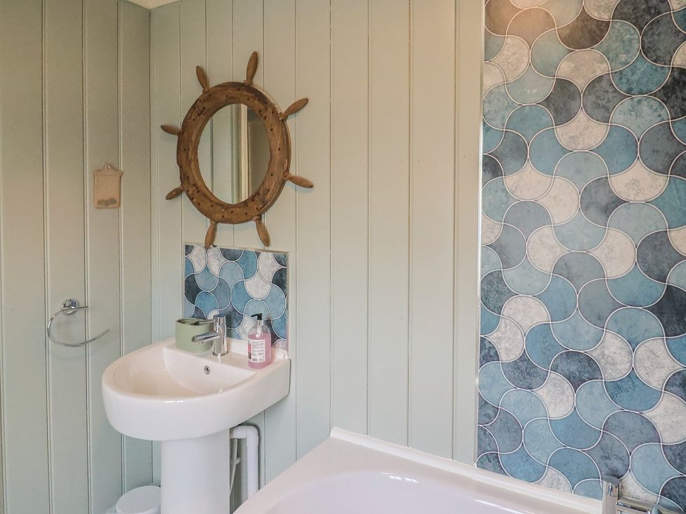 A bathroom with a sink and mirror at 5B Bridge Street Lyme Regis