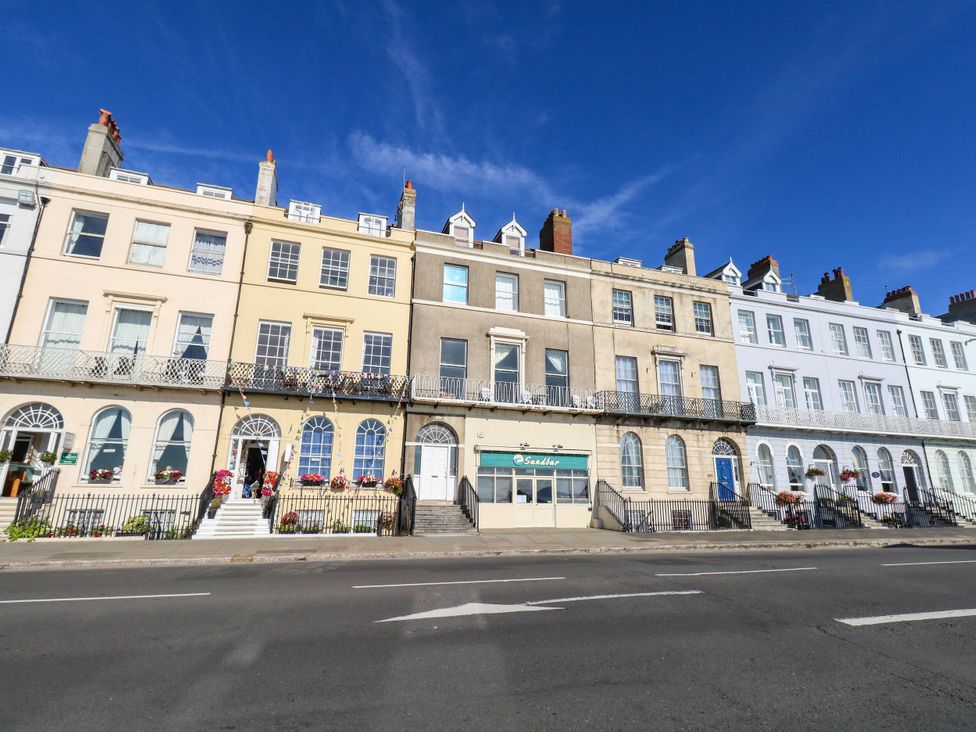 A row of buildings with balconies and windows in Weymouth