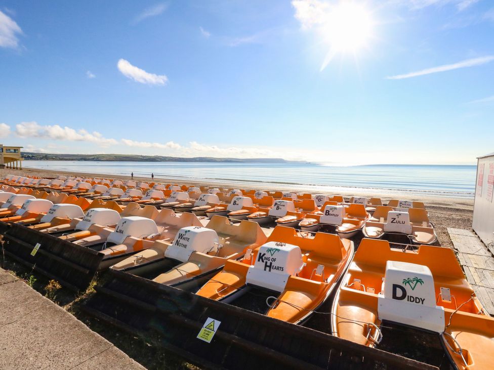 A row of pedal boats on a beach at 123 On The Sea - The Cubby, Weymouth