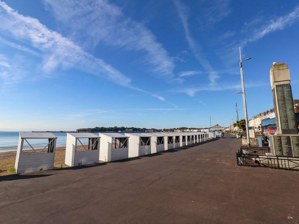 A row of beach huts by the sea at 123 On The Sea - The Cubby Weymouth