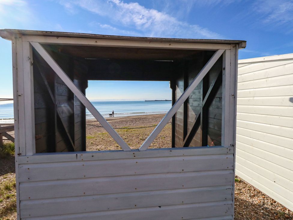 A view through a hut towards the beach and sea at 123 On The Sea - The Cubby, Weymouth