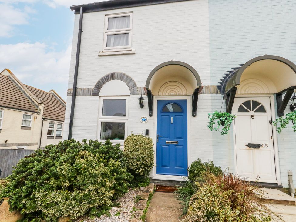 A front entrance with a blue door and window at 23 The Maltings in Weymouth